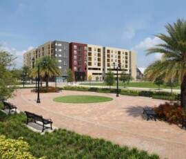 Exterior view of The Ella at ENCORE! with plaza, palm trees and benches