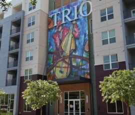 Main entrance of The Trio at ENCORE! featuring jazz musician mural
