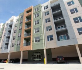 Side exterior view of The Trio at ENCORE! with covered parking garage