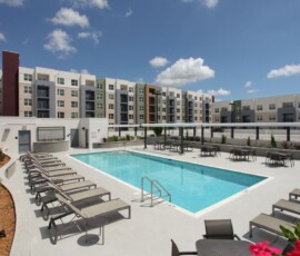 Resort-style pool deck with lounge chairs at The Trio at ENCORE!