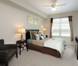 Spacious bedroom with ceiling fan and natural light at The Trio at ENCORE!