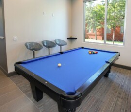 Game room with billiard table and modern seating at The Trio at ENCORE!