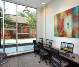 Business center with computers and colorful artwork at The Trio at ENCORE!