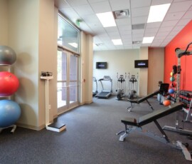 Fitness center with cardio equipment and exercise balls at The Trio at ENCORE!