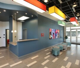 Modern lobby entrance with colorful ceiling lights at The Trio at ENCORE!