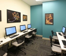 Computer room with workstations and music-themed artwork on the walls