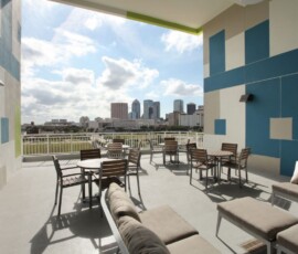 Rooftop terrace with outdoor seating and panoramic view of Tampa skyline