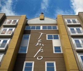 Exterior facade of The Tempo at ENCORE! with building signage and balconies