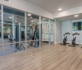Modern fitness center with spin bikes and weight room at Legacy ENCORE! Luxury Apartments
