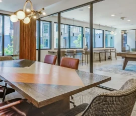 Private conference room with wood table, leather chairs and pool table at Navara at ENCORE!