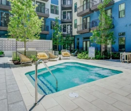 Outdoor spa and courtyard lounge area with string lights at Navara at ENCORE!