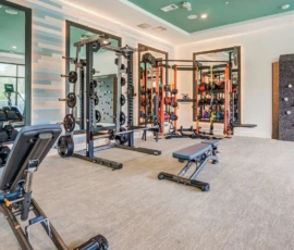 State-of-the-art fitness center with weight racks, climbing wall and free weights at Navara at ENCORE!